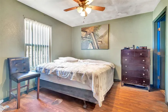 a bedroom with a bed and window