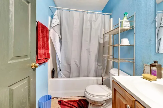 a white toilet sitting next to a bathroom sink