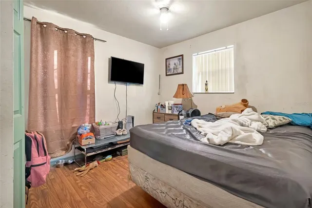 a bedroom with a bed and flat screen tv