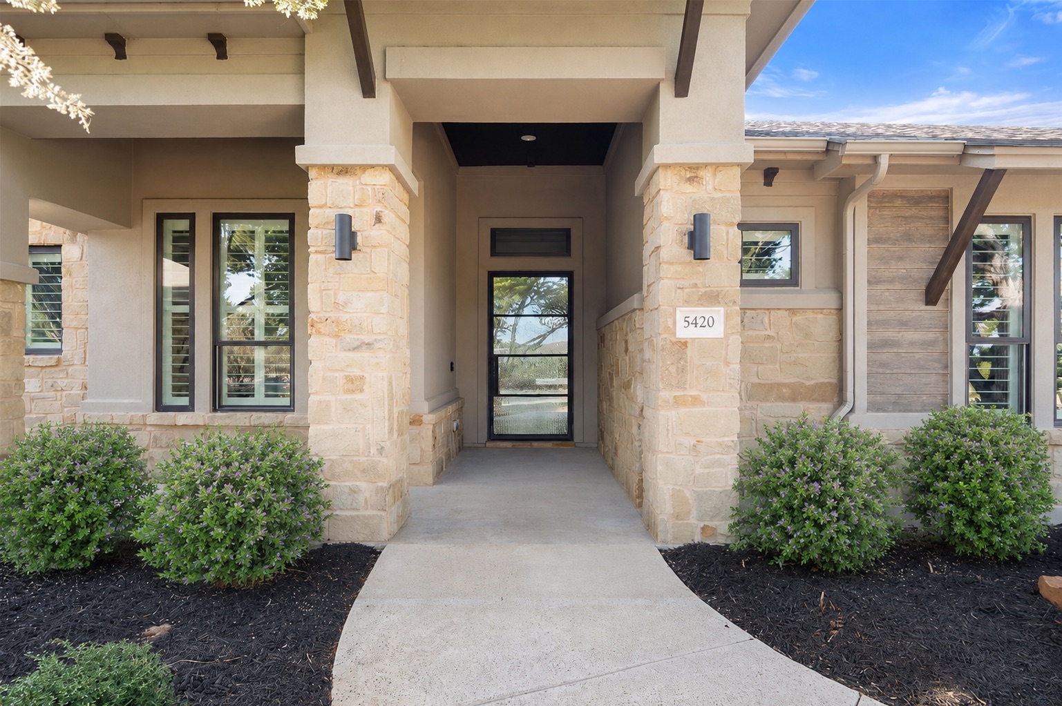 5420 Destination Way Jonestown, TX 78645 - Photo 1 of 39 Elegant stone and stucco facade with a contemporary glass entry door. Come on in...