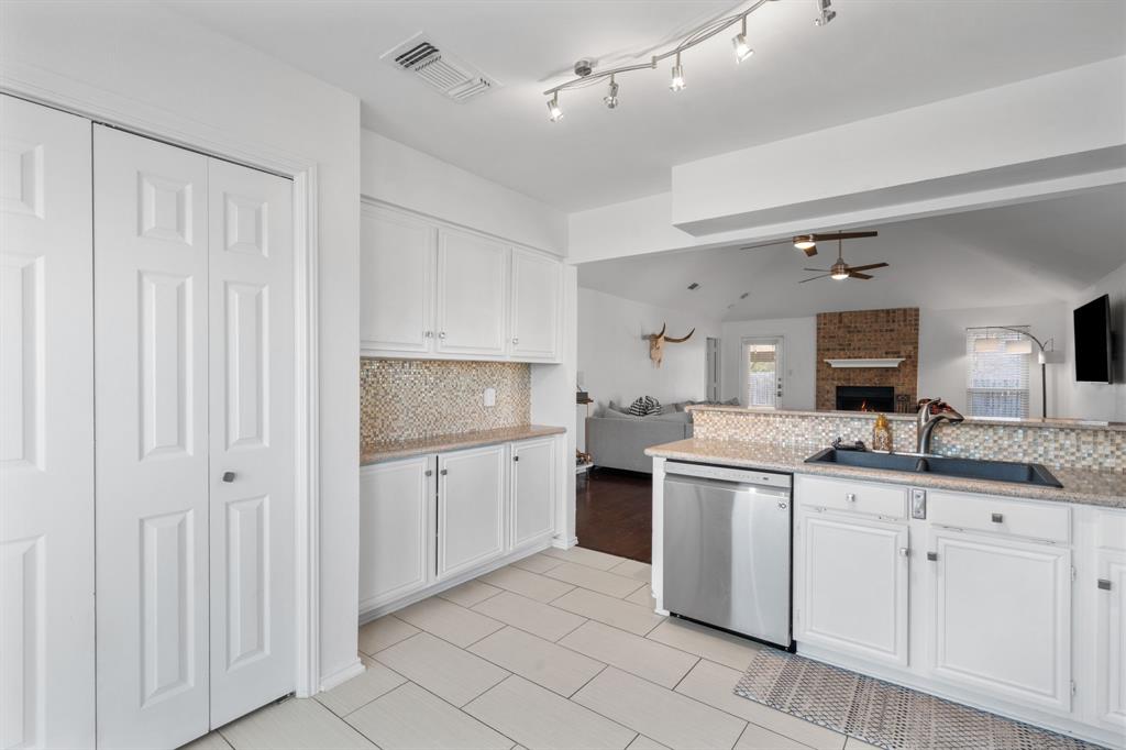 604 Lionel Way Fort Worth, TX 76108 - Photo 15 of 36 a kitchen with white cabinets and sink