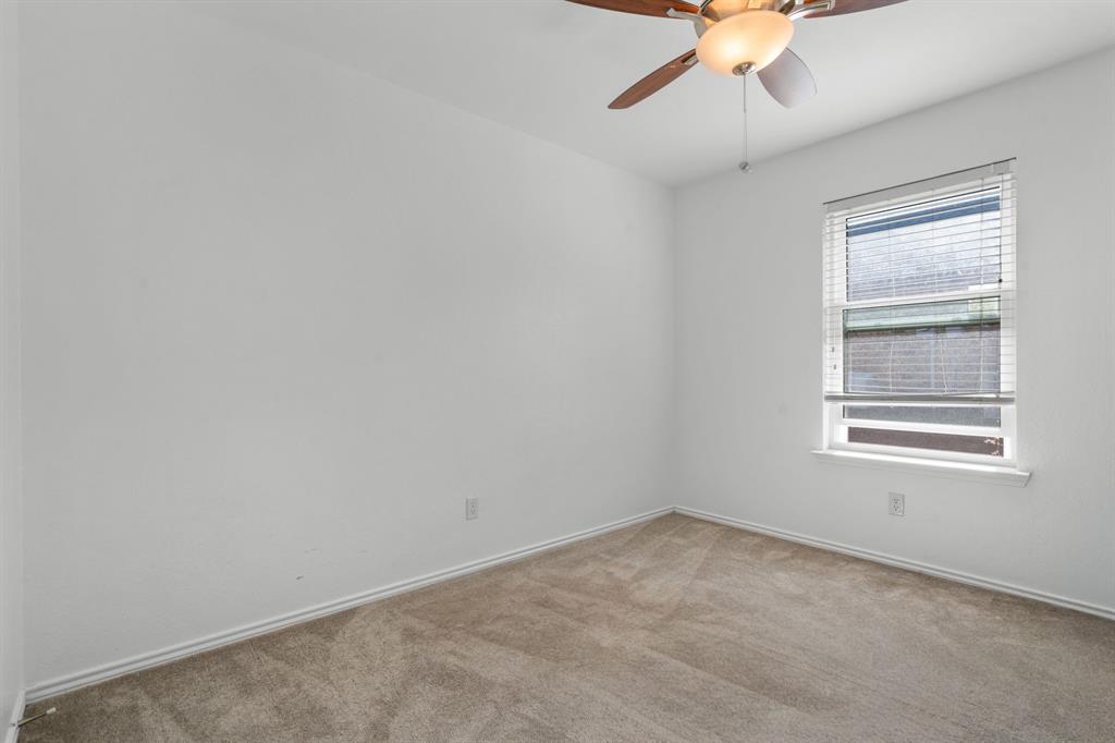 604 Lionel Way Fort Worth, TX 76108 - Photo 19 of 36 an empty room with a chandelier fan and windows