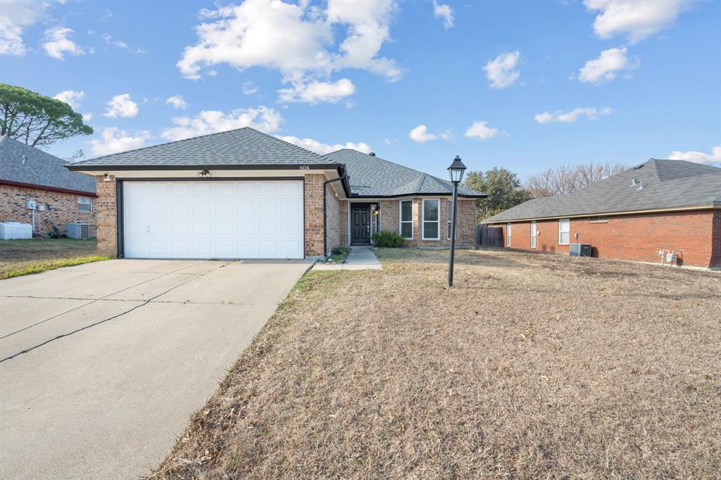604 Lionel Way Fort Worth, TX 76108 - Photo 2 of 36 a front view of a house with a yard and garage