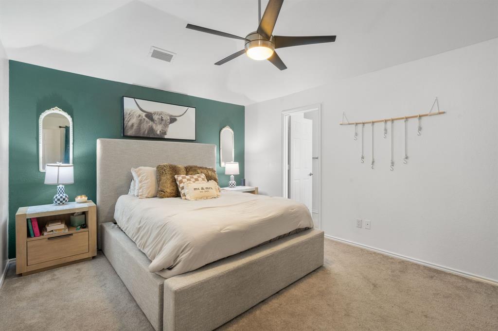 604 Lionel Way Fort Worth, TX 76108 - Photo 23 of 36 a bedroom with a bed and a chandelier