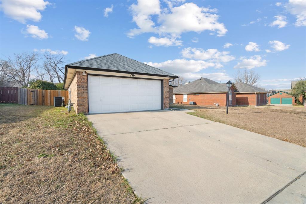 604 Lionel Way Fort Worth, TX 76108 - Photo 3 of 36 a front view of a house with a yard and garage