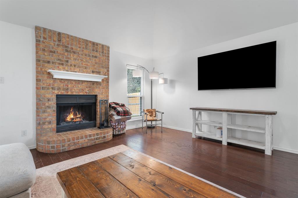 604 Lionel Way Fort Worth, TX 76108 - Photo 10 of 36 a living room with furniture and a fireplace