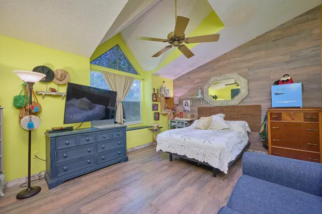 a bedroom with a bed and a couch