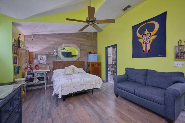 a bedroom with a bed and a flat screen tv