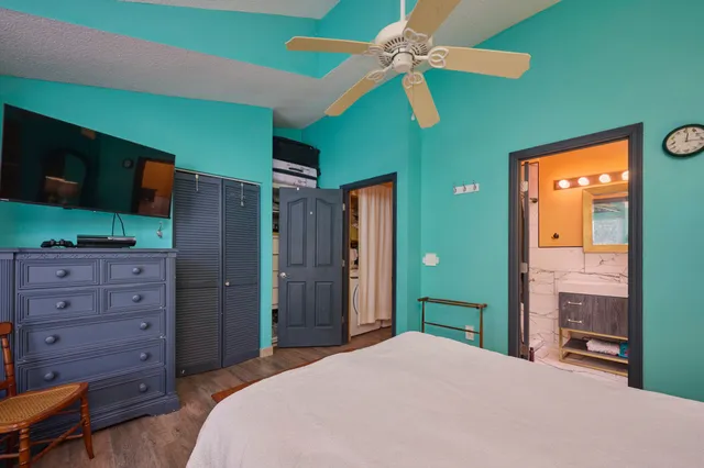 a bedroom with a bed and a flat screen tv