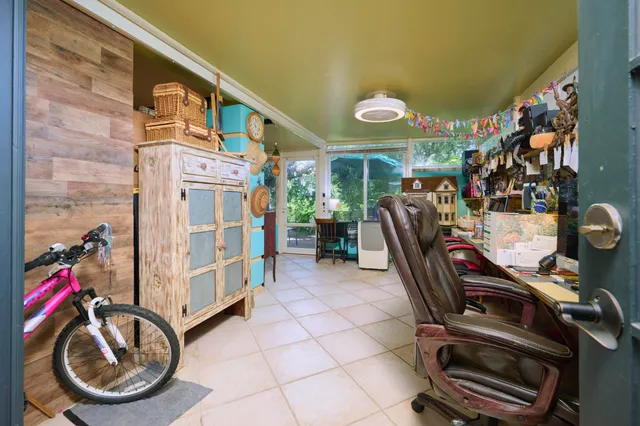 a living room filled with furniture and a floor to ceiling window