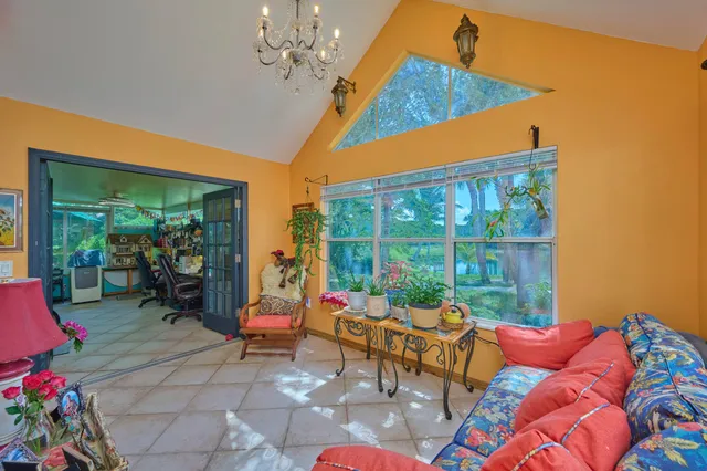 a bedroom with furniture and a chandelier