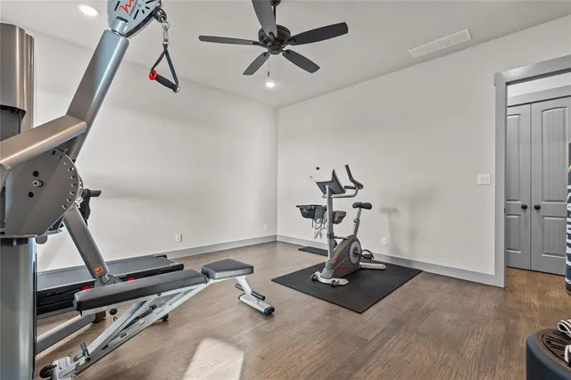a bedroom with a bed and a flat tv screen on the dresser