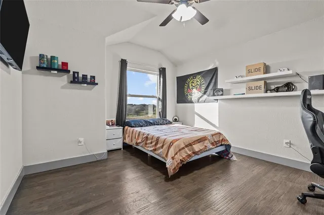 a view of a livingroom with wooden floor and a ceiling fan