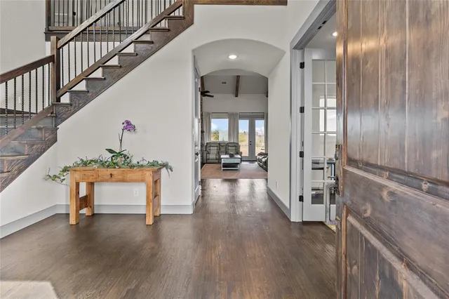 a view of entryway and hall with wooden floor