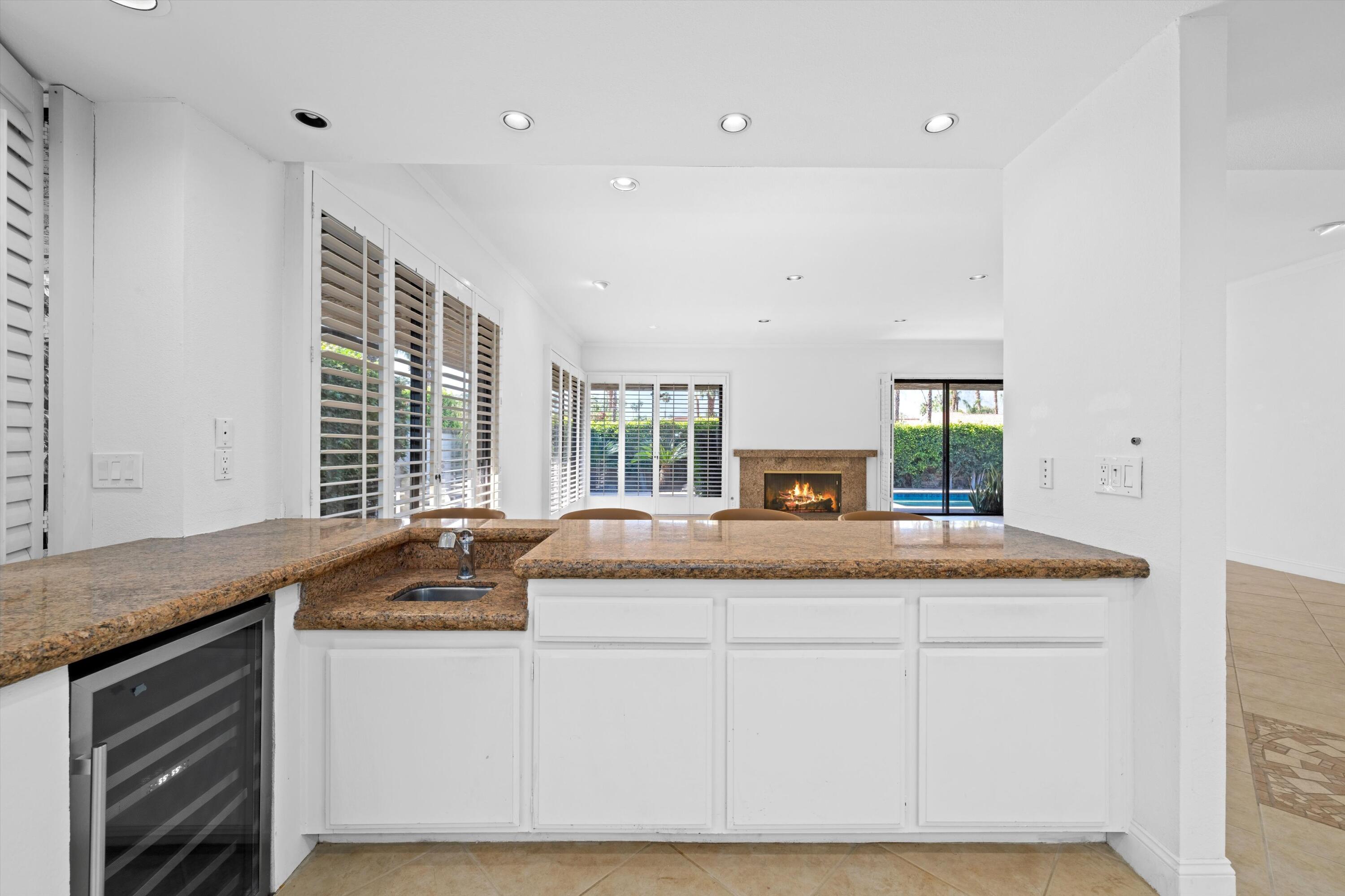 75 Colgate Drive Rancho Mirage, CA 92270 - Photo 12 of 40 a view of living room with granite countertop furniture and fireplace
