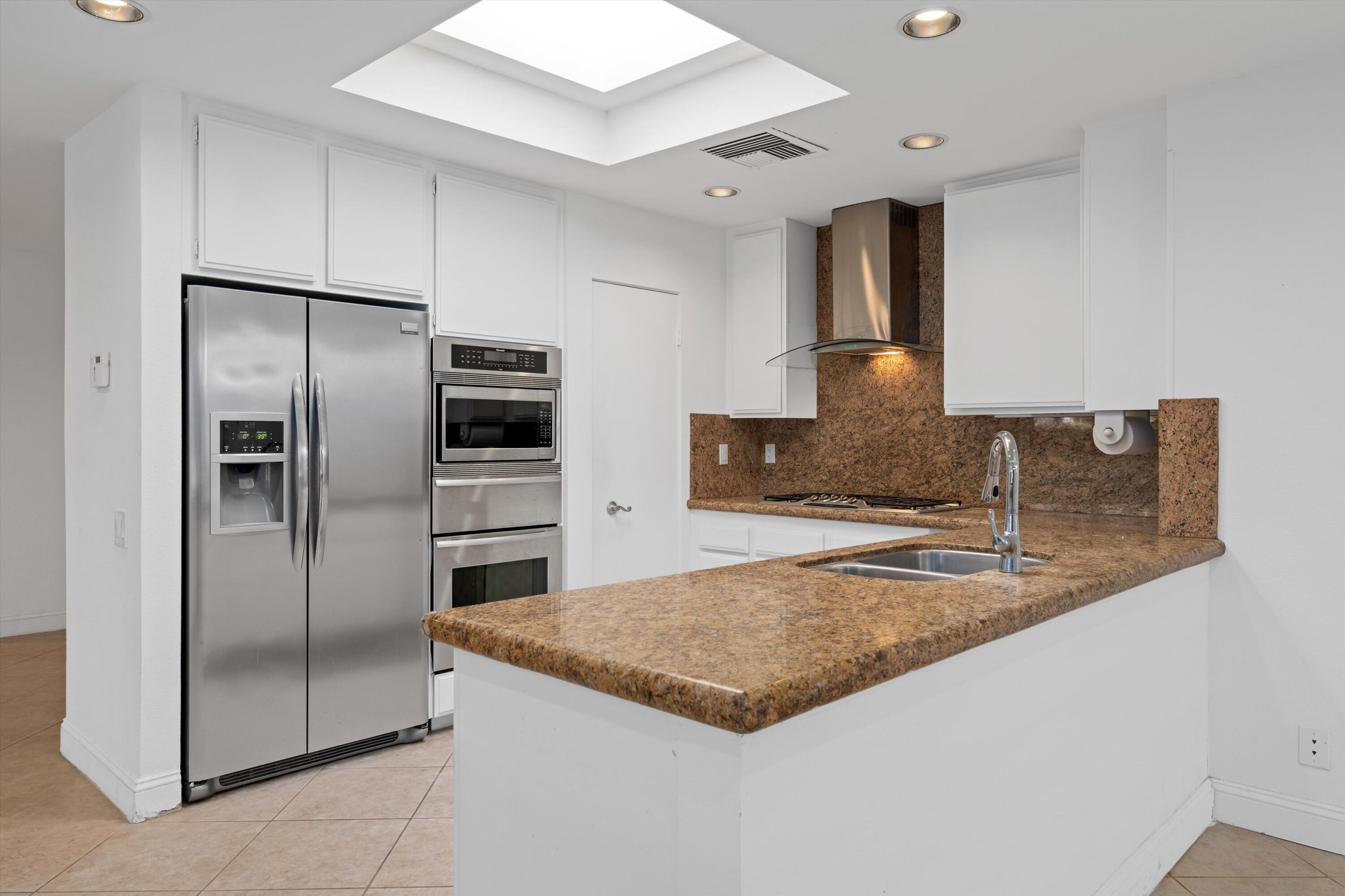 75 Colgate Drive Rancho Mirage, CA 92270 - Photo 13 of 40 a kitchen with stainless steel appliances granite countertop a refrigerator and a sink