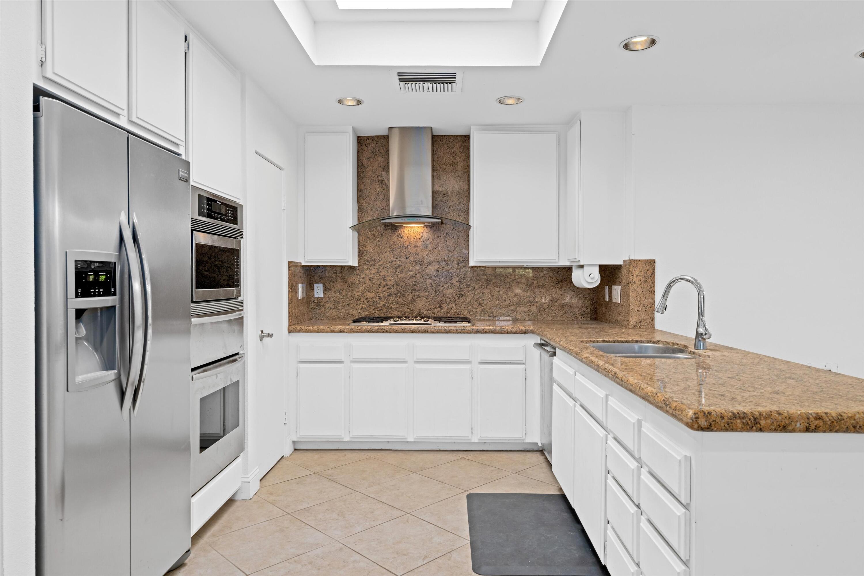 75 Colgate Drive Rancho Mirage, CA 92270 - Photo 15 of 40 a kitchen with stainless steel appliances granite countertop a refrigerator and a sink