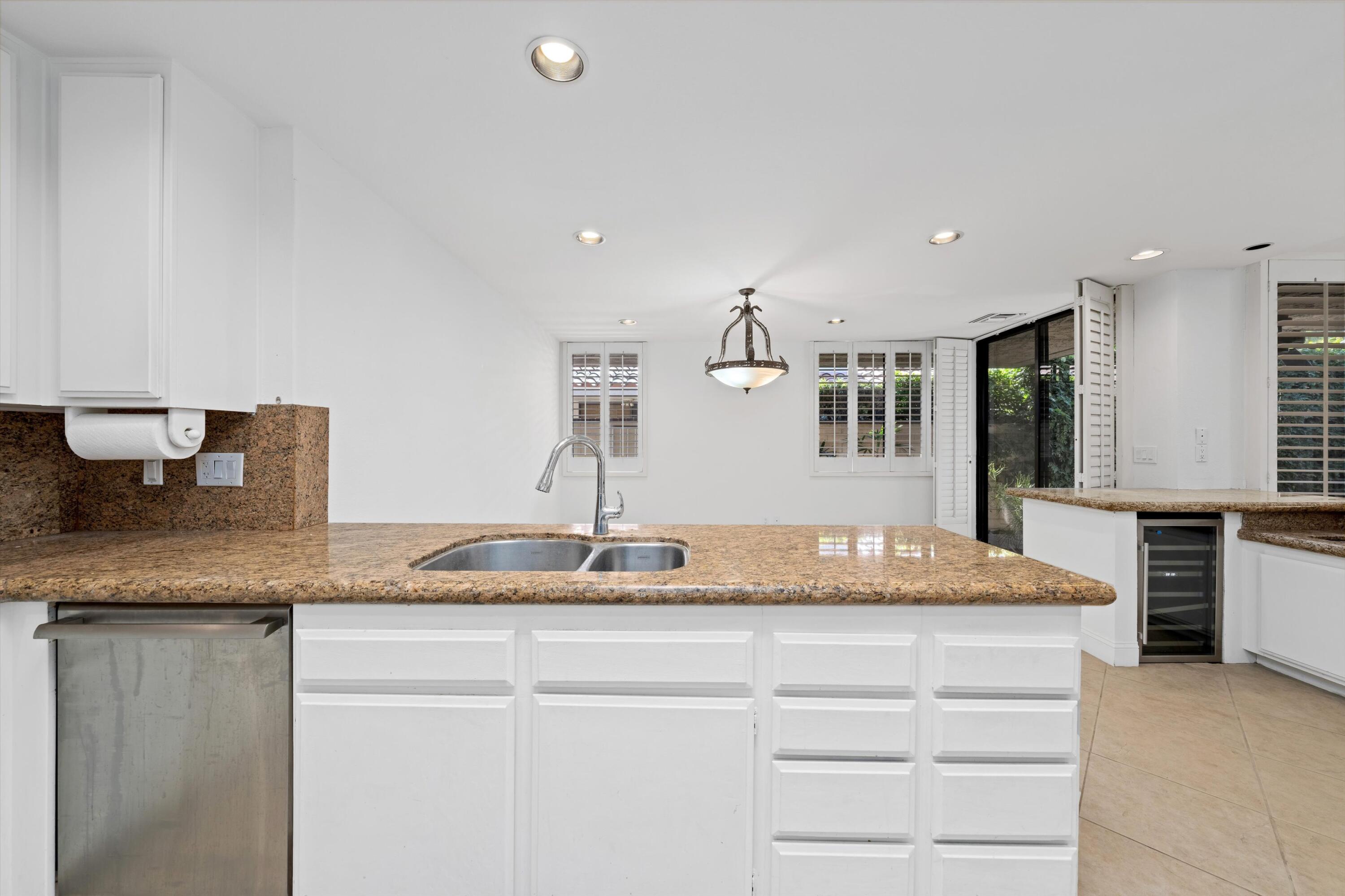75 Colgate Drive Rancho Mirage, CA 92270 - Photo 16 of 40 a kitchen with stainless steel appliances granite countertop a sink and a granite counter tops