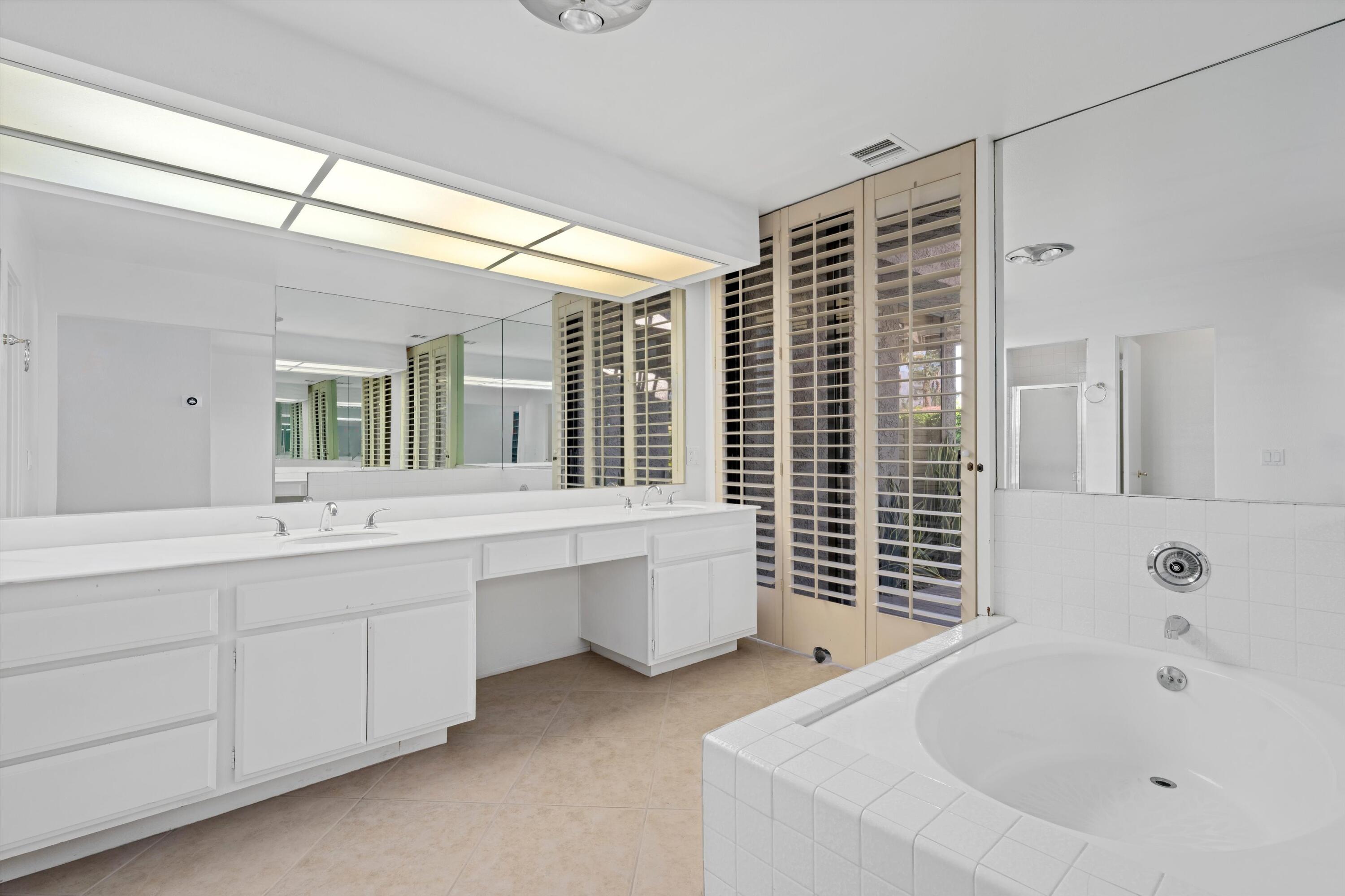 75 Colgate Drive Rancho Mirage, CA 92270 - Photo 20 of 40 a bathroom with a bathtub sink and mirror