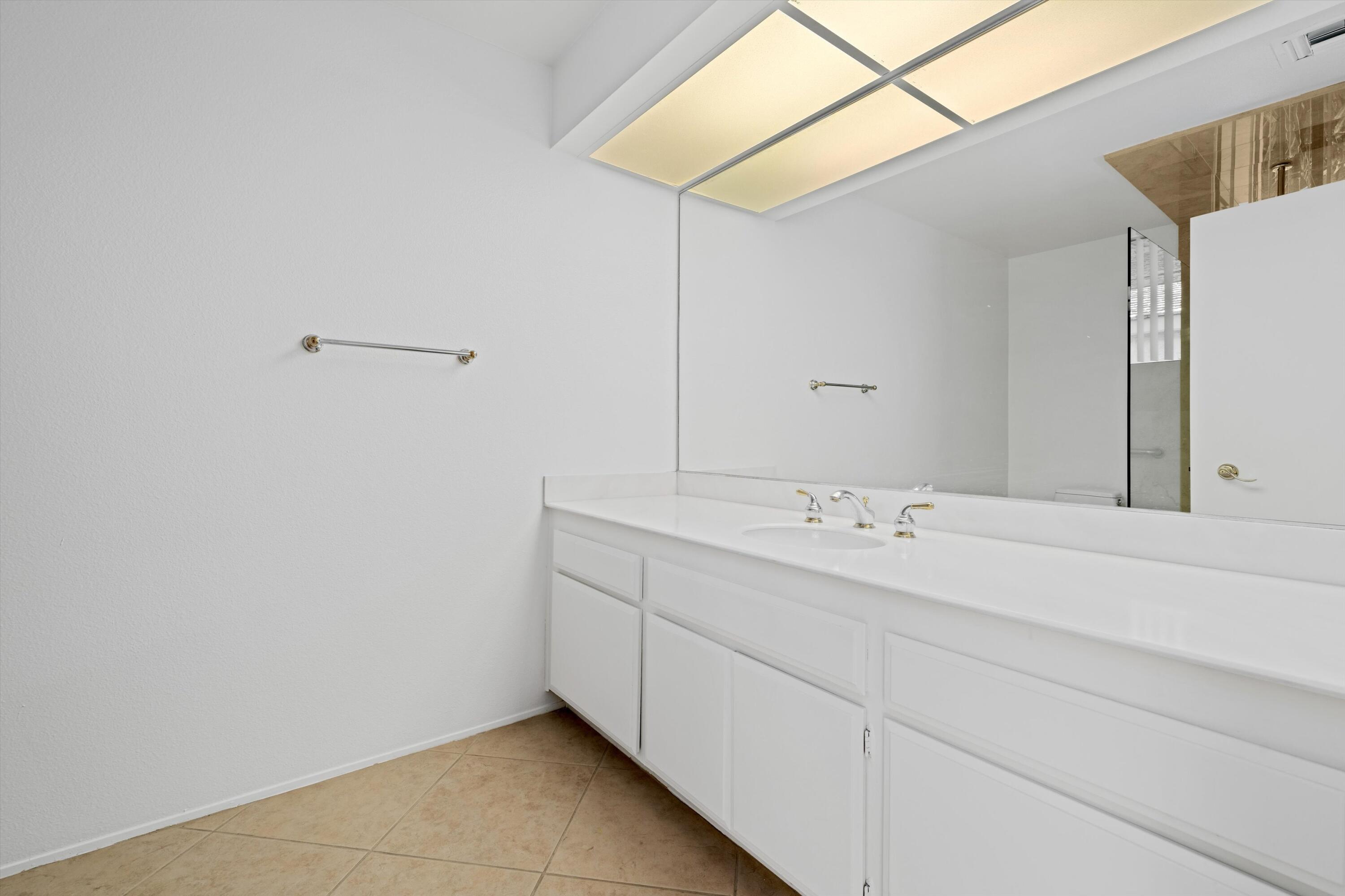 75 Colgate Drive Rancho Mirage, CA 92270 - Photo 24 of 40 a bathroom with a double vanity sink and mirror