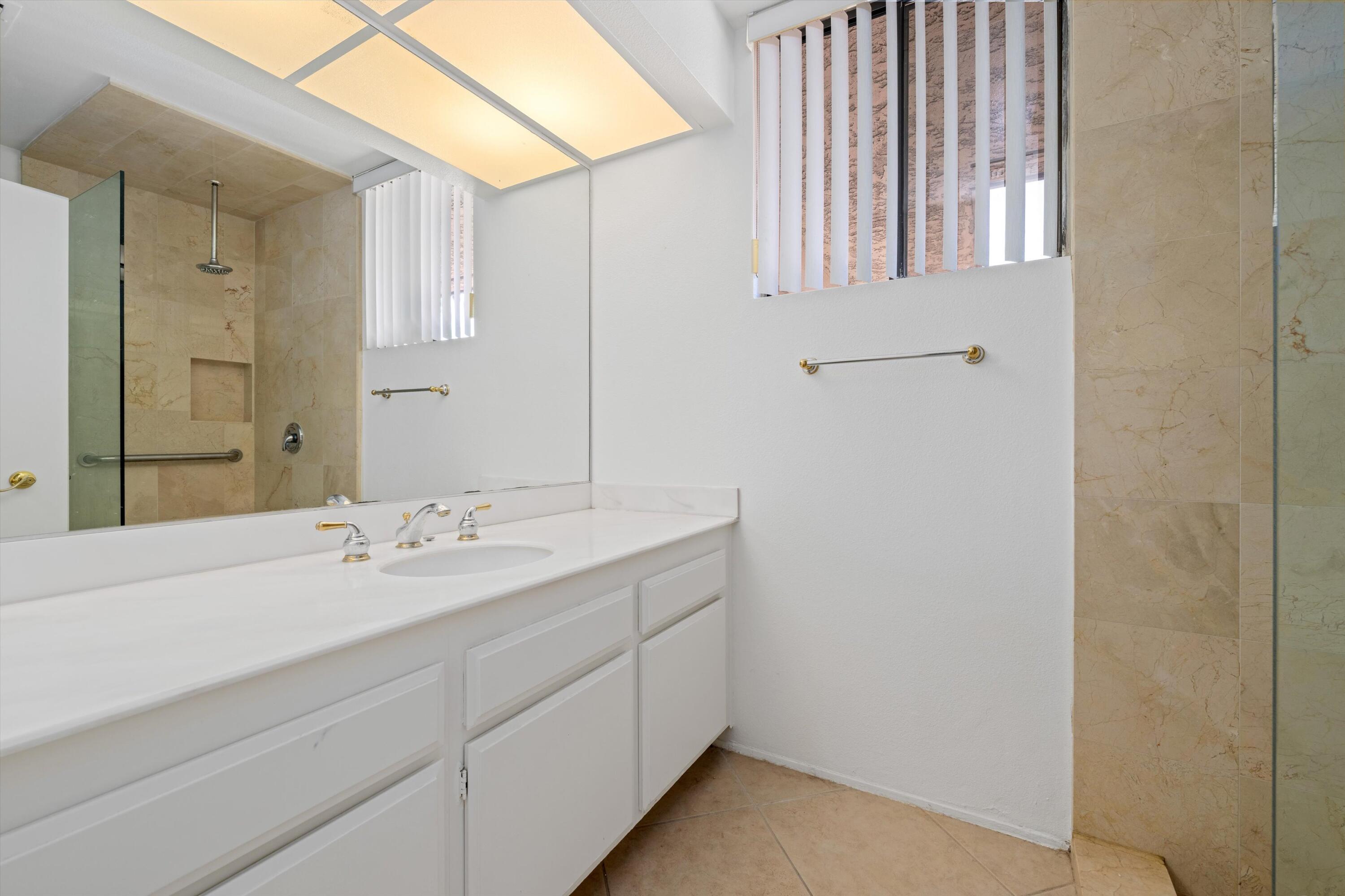 75 Colgate Drive Rancho Mirage, CA 92270 - Photo 27 of 40 a bathroom with a double vanity sink and a mirror