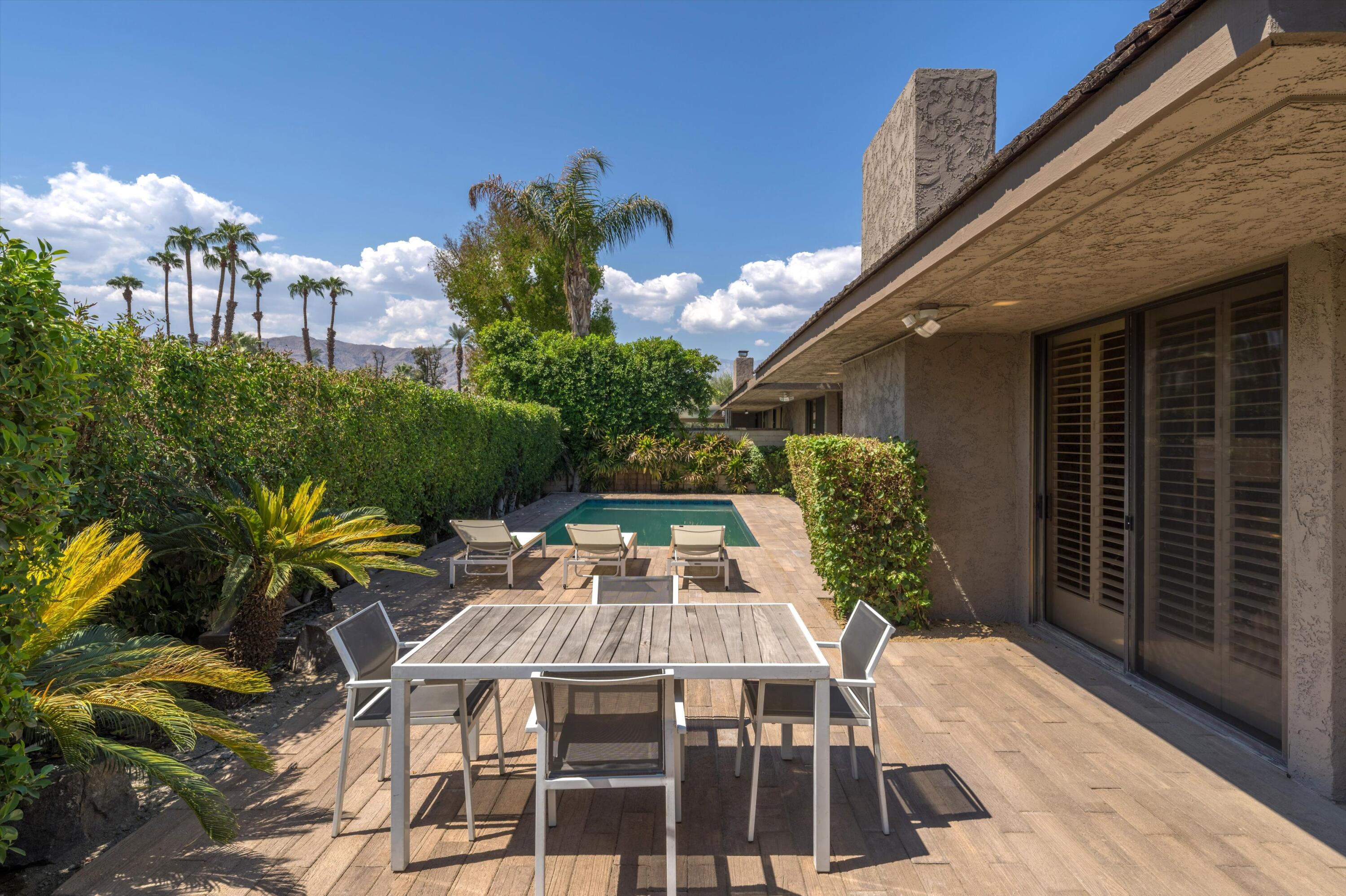 75 Colgate Drive Rancho Mirage, CA 92270 - Photo 30 of 40 a view of a patio with table and chairs and potted plants