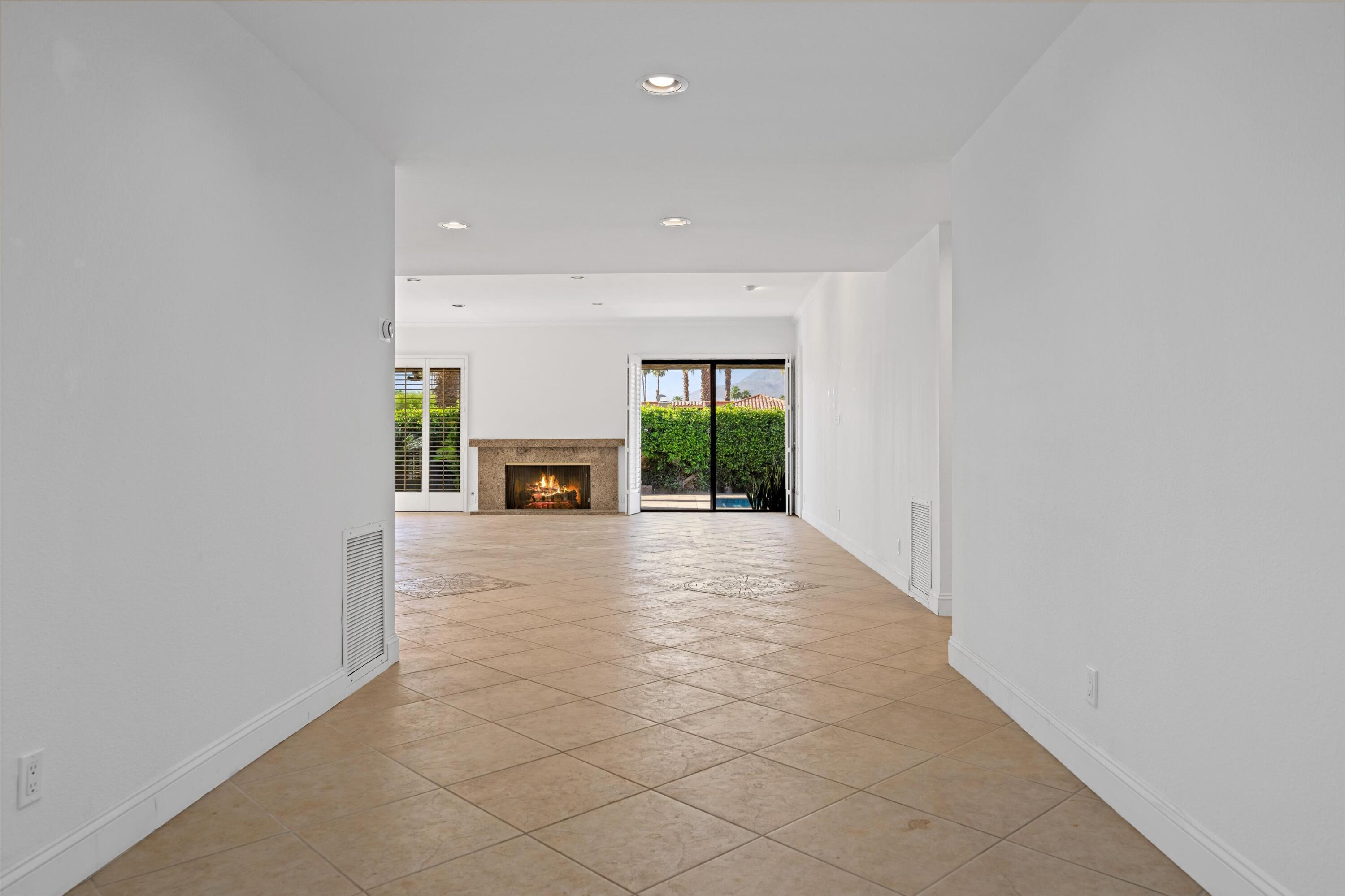 75 Colgate Drive Rancho Mirage, CA 92270 - Photo 4 of 40 an empty room with fireplace and a window