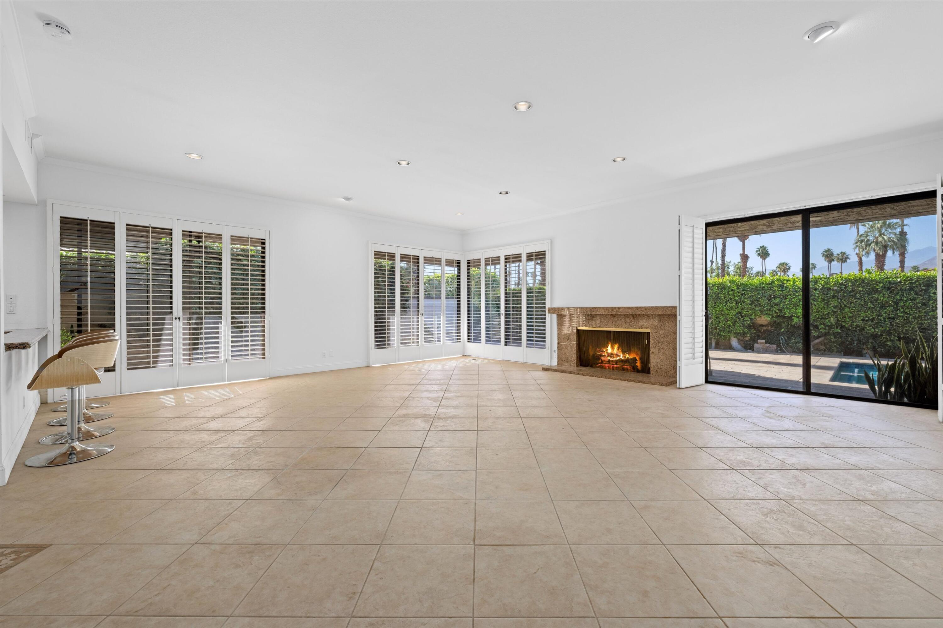 75 Colgate Drive Rancho Mirage, CA 92270 - Photo 5 of 40 a view of an empty room with a fireplace and a large window