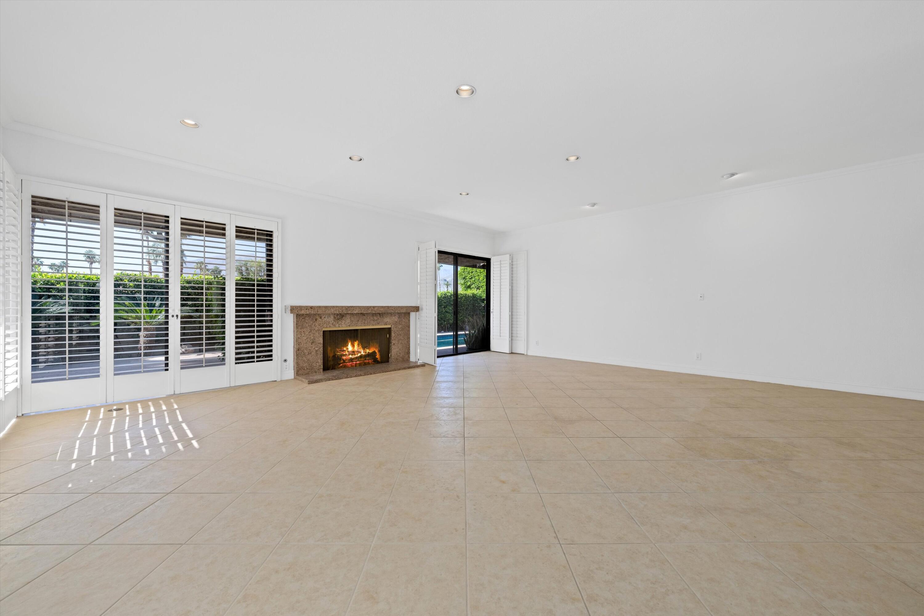 75 Colgate Drive Rancho Mirage, CA 92270 - Photo 8 of 40 a view of an empty room with a window and fireplace
