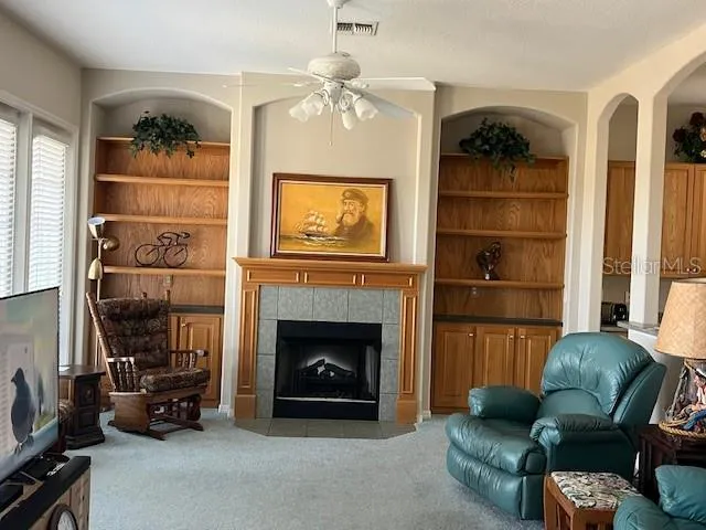 a living room with furniture and a fireplace