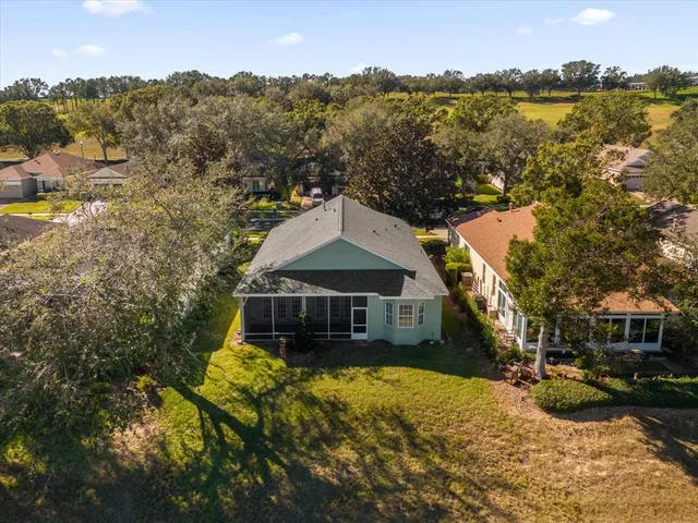 an aerial view of house with yard swimming pool and outdoor seating