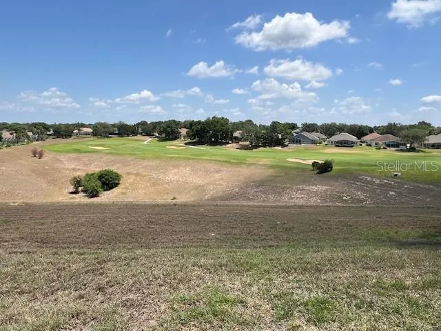 a living room with furniture ceiling fan and a flat screen tv
