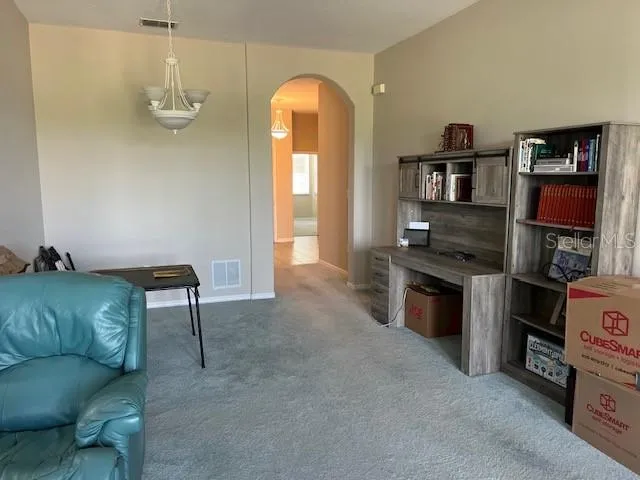 a bedroom with a bed a desk and chair