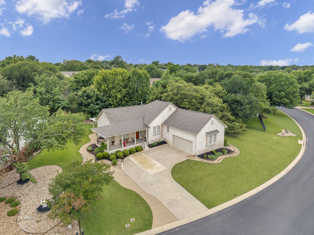 144 Cattle Trail Way Georgetown, TX 78633 - Photo 30 of 37 An inviting front porch with tasteful landscaping adorns this lovely residence.