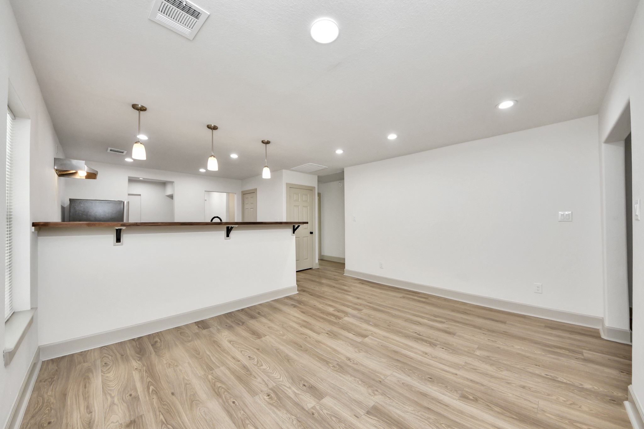 2919 Rosedale Street, Unit B Houston, TX 77004 - Photo 17 of 35 an empty room with wooden floor and windows