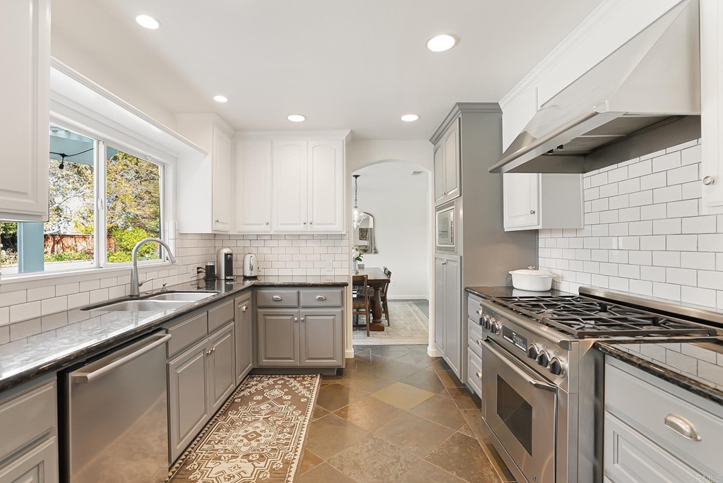 4966 Park Drive Carlsbad, CA 92008 - Photo 12 of 45 a kitchen with stainless steel appliances granite countertop a sink stove and refrigerator