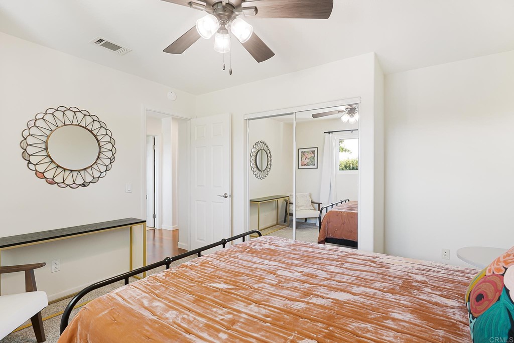 4966 Park Drive Carlsbad, CA 92008 - Photo 23 of 45 a bedroom with a bed and a chandelier