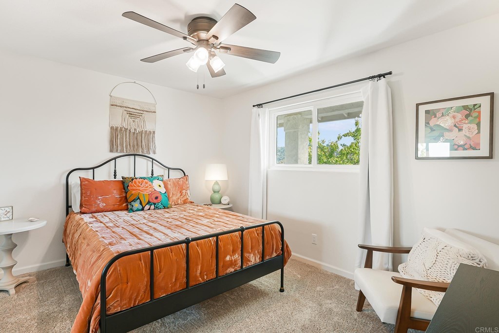 4966 Park Drive Carlsbad, CA 92008 - Photo 24 of 45 a bedroom with a bed and a chandelier