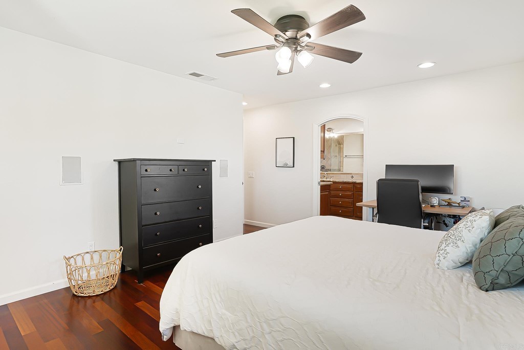4966 Park Drive Carlsbad, CA 92008 - Photo 30 of 45 a bedroom with a bed and wooden floor