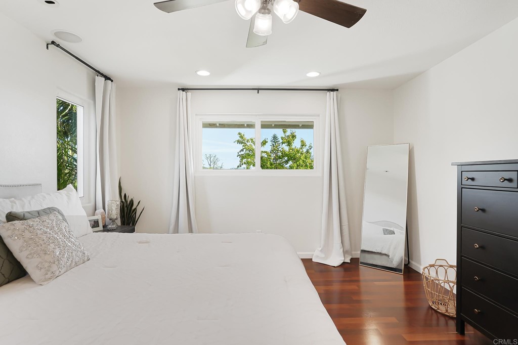 4966 Park Drive Carlsbad, CA 92008 - Photo 31 of 45 a bedroom with a bed and a chandelier