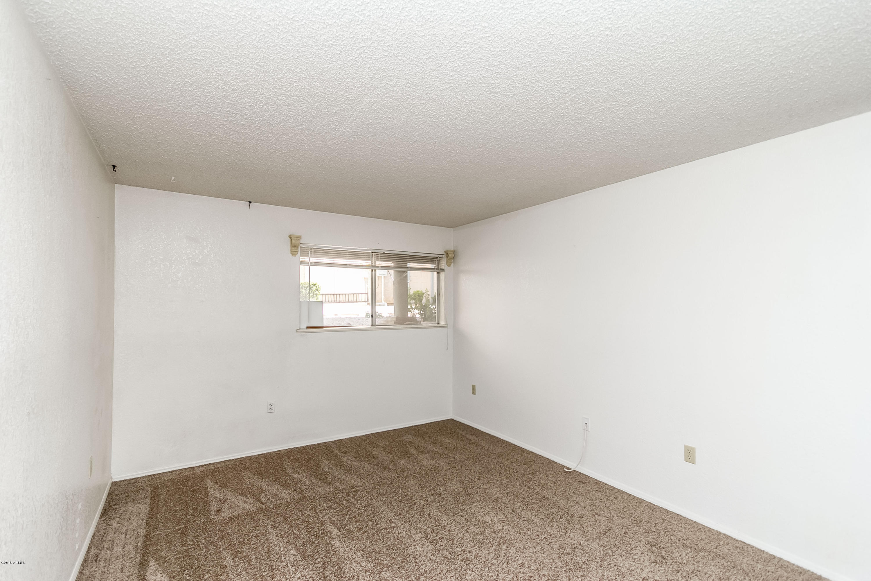 1645 West Baseline Road, Unit 1160 Mesa, AZ 85202 - Photo 16 of 27 an empty room with a window
