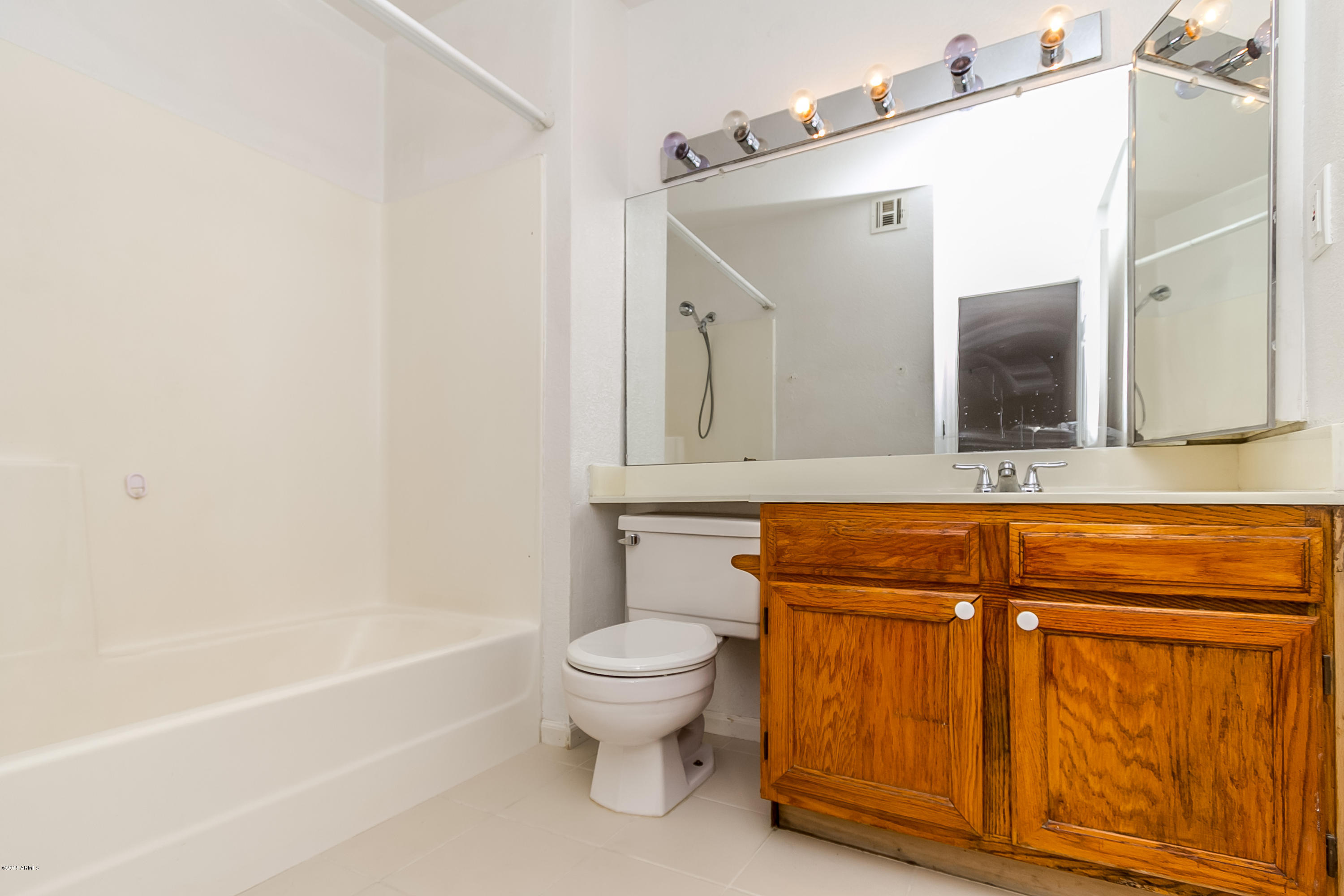 1645 West Baseline Road, Unit 1160 Mesa, AZ 85202 - Photo 17 of 27 a bathroom with a toilet sink and mirror