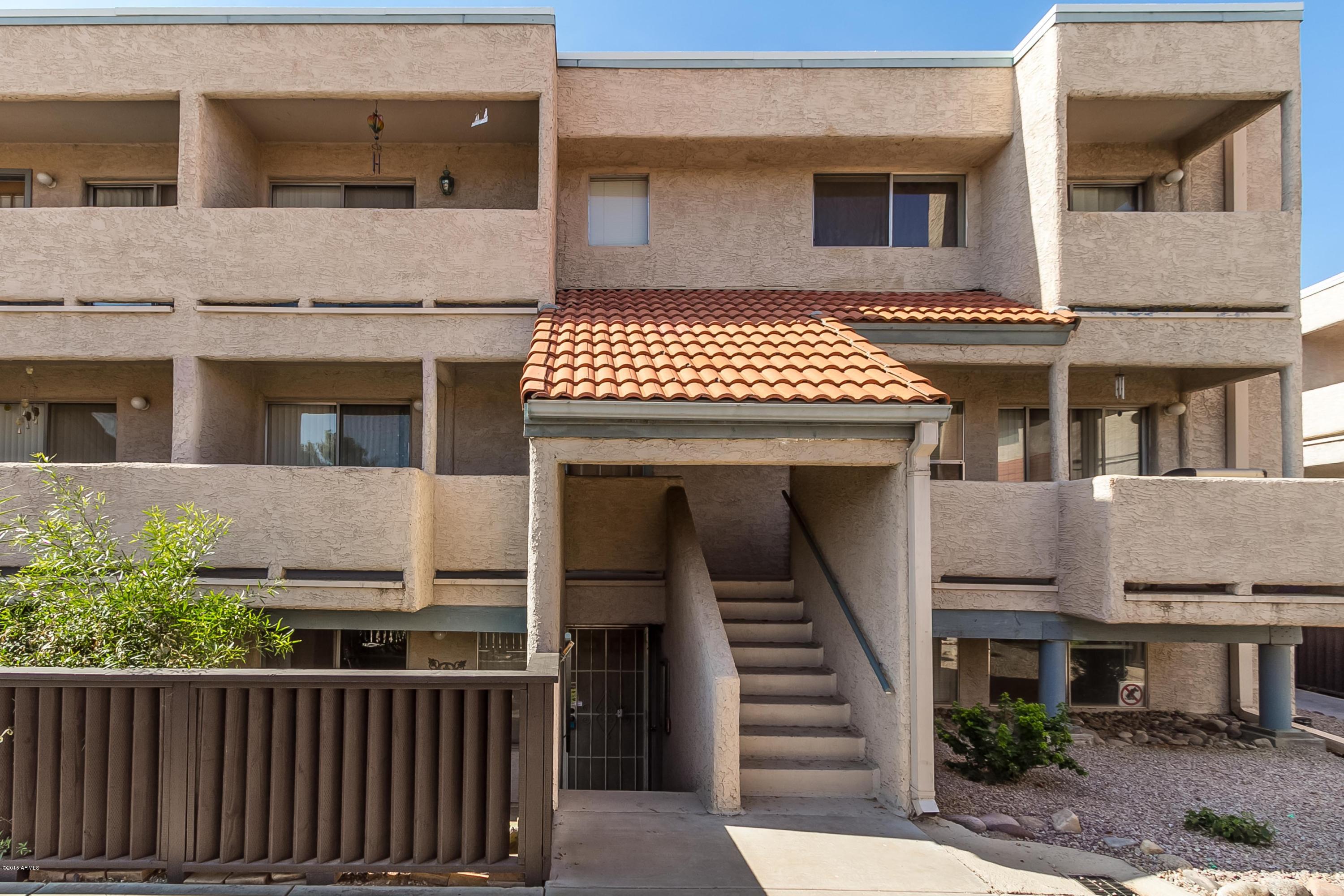 1645 West Baseline Road, Unit 1160 Mesa, AZ 85202 - Photo 2 of 27 a front view of a house with a fence