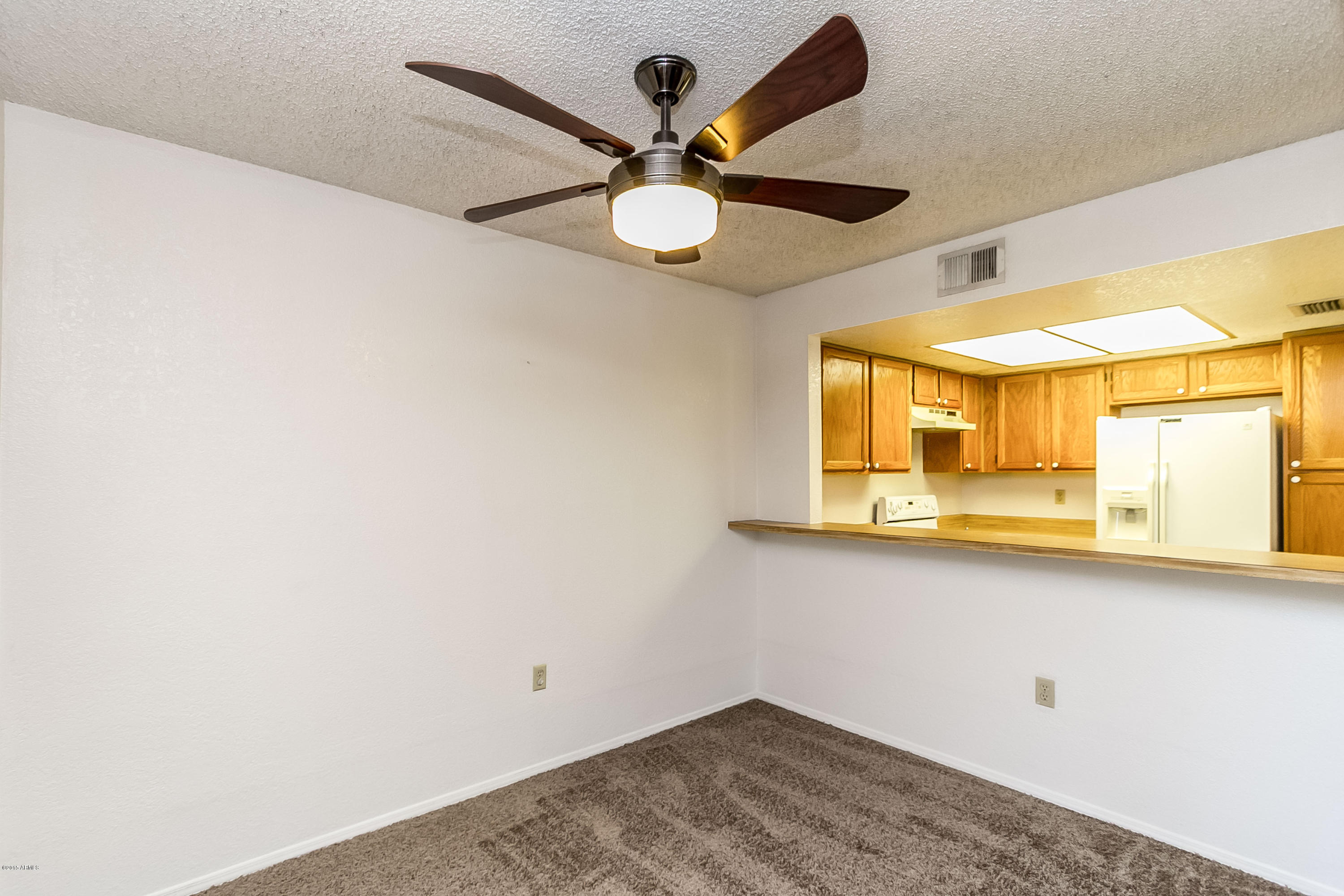 1645 West Baseline Road, Unit 1160 Mesa, AZ 85202 - Photo 10 of 27 an empty room with a window and a ceiling fan