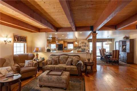 a living room with furniture and wooden floors