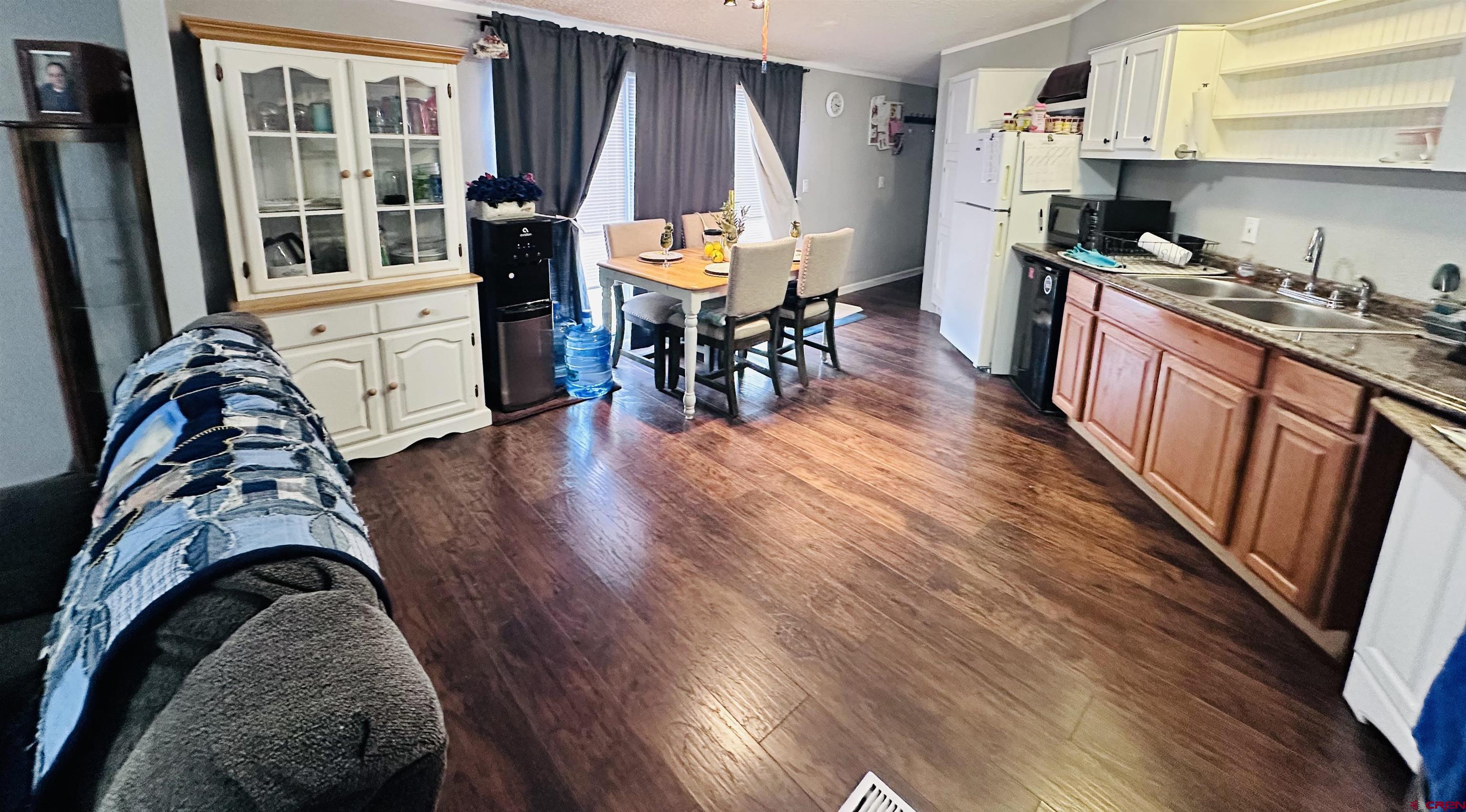 62880 Lasalle Road, Unit 174 Montrose, CO 81401 - Photo 14 of 23 a kitchen with stainless steel appliances granite countertop wooden floors a stove and a sink