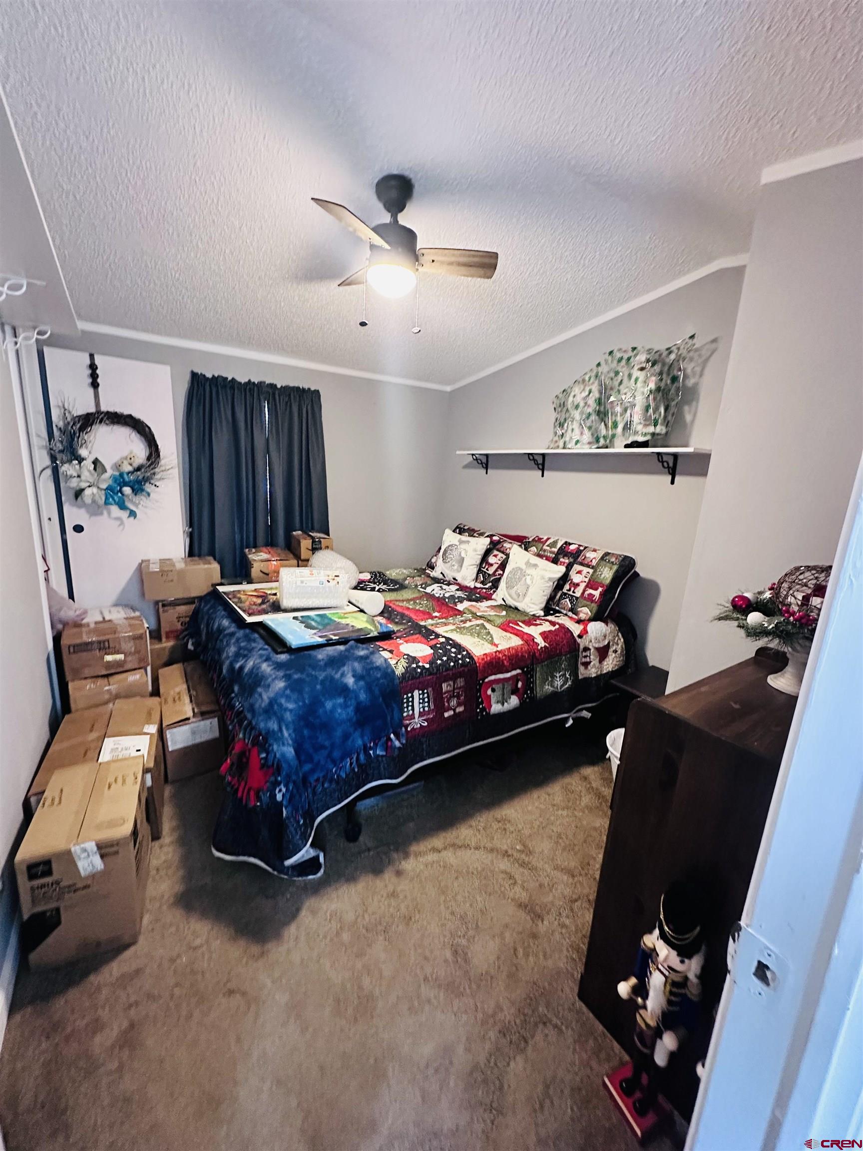 62880 Lasalle Road, Unit 174 Montrose, CO 81401 - Photo 18 of 23 a bedroom with bed and a chandelier