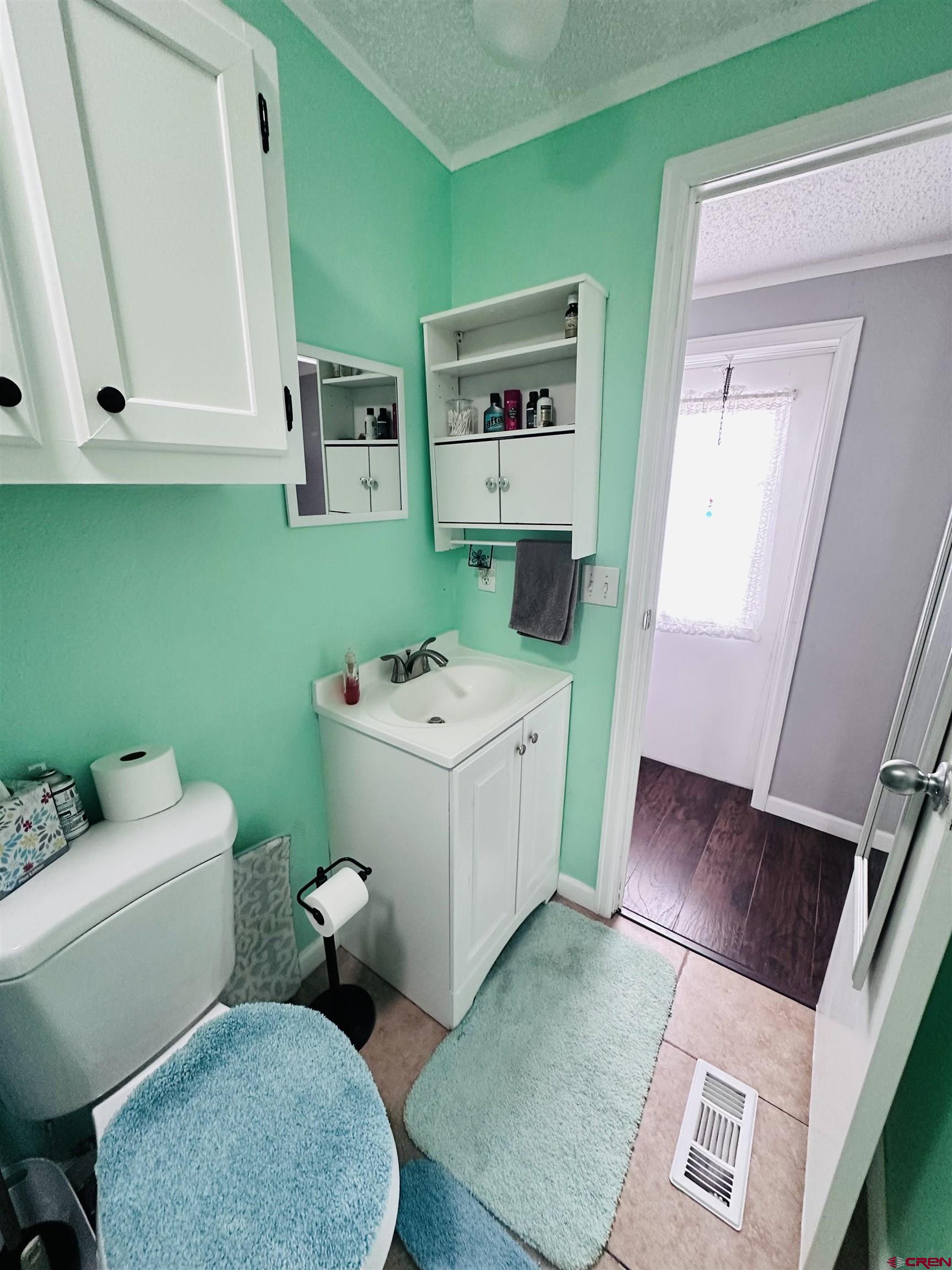 62880 Lasalle Road, Unit 174 Montrose, CO 81401 - Photo 22 of 23 a bathroom with a sink mirror vanity and toilet