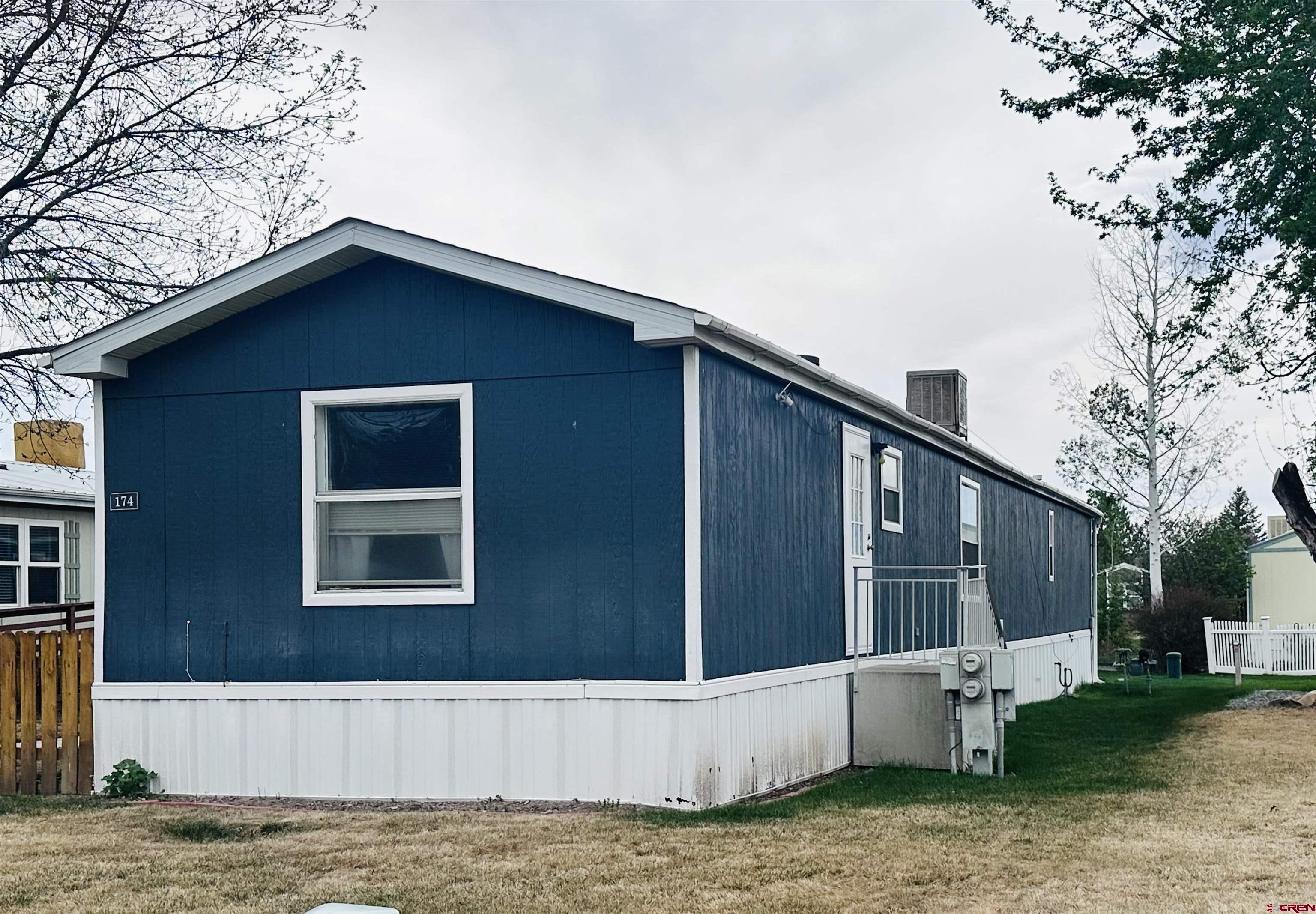 62880 Lasalle Road, Unit 174 Montrose, CO 81401 - Photo 4 of 23 a view of a house with a yard