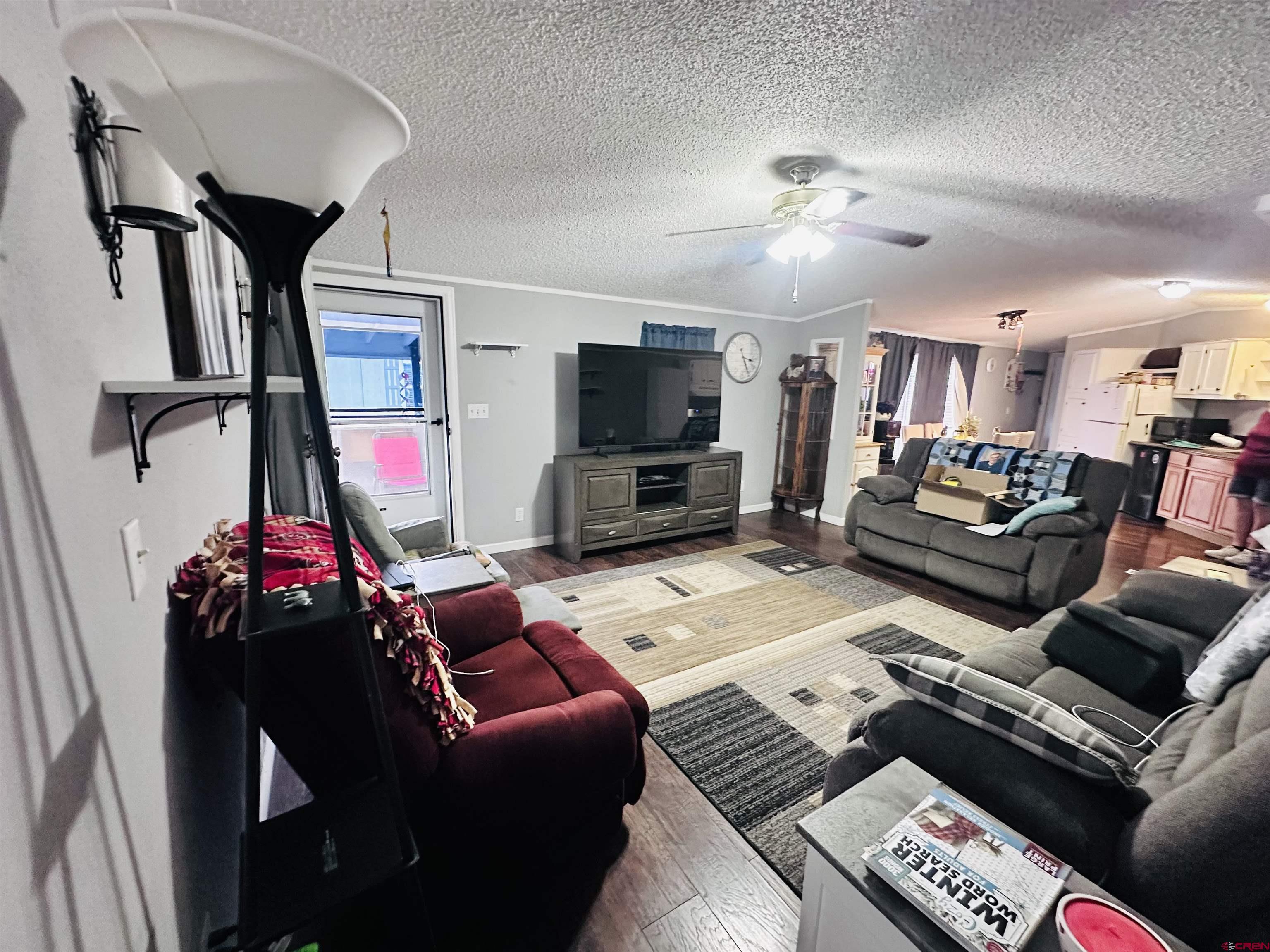 62880 Lasalle Road, Unit 174 Montrose, CO 81401 - Photo 6 of 23 a living room with furniture and a flat screen tv